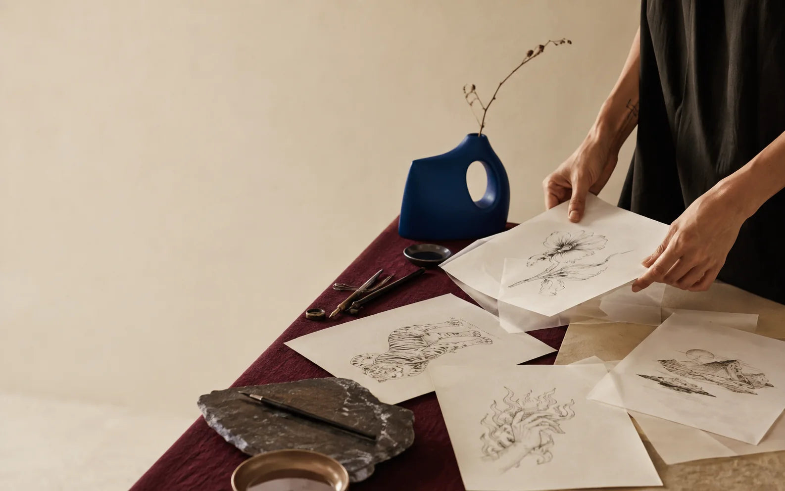 Original fine-line artwork being arranged in the SuperInkLab studio
