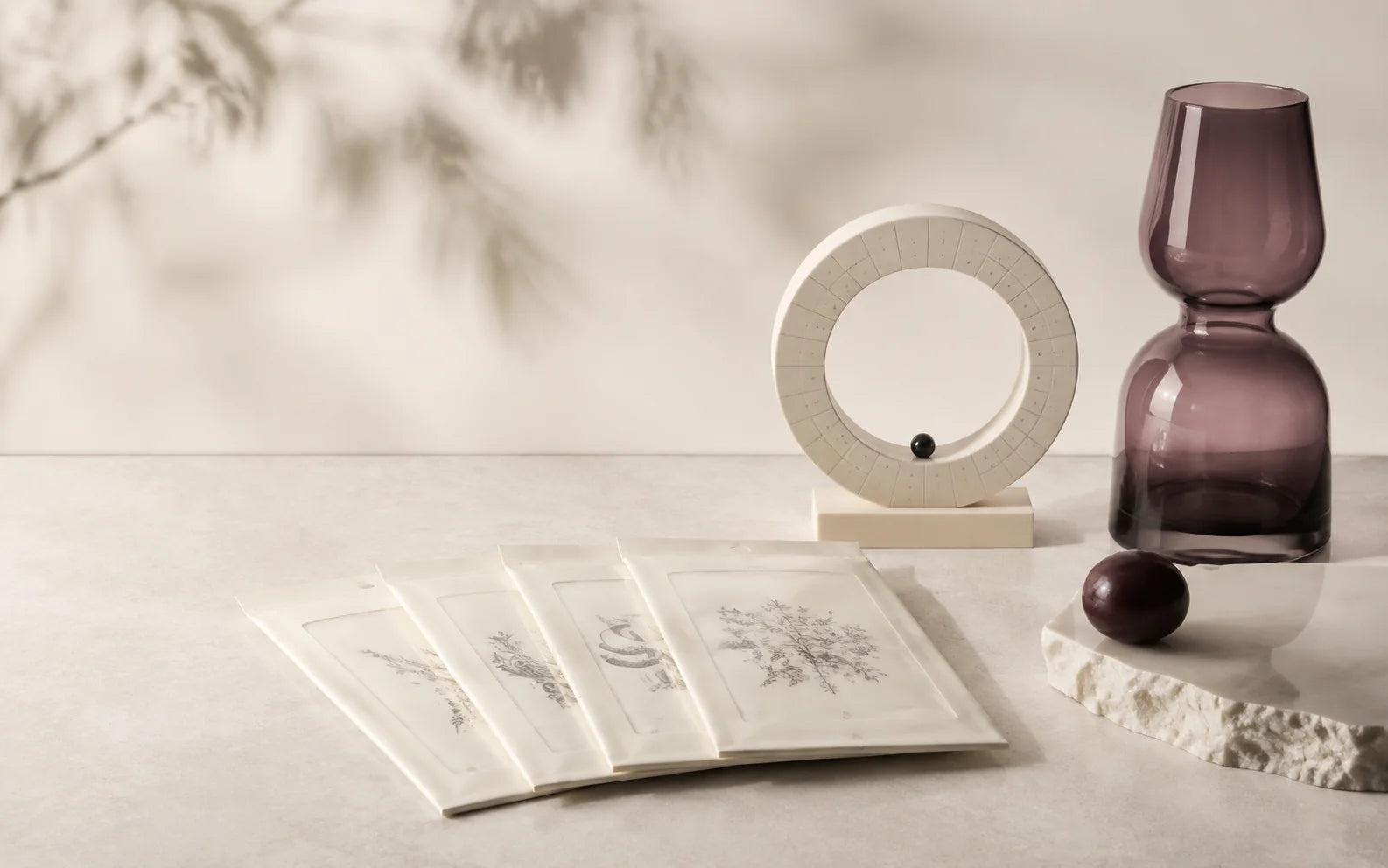 A considered arrangement of temporary tattoo packs and sculptural objects